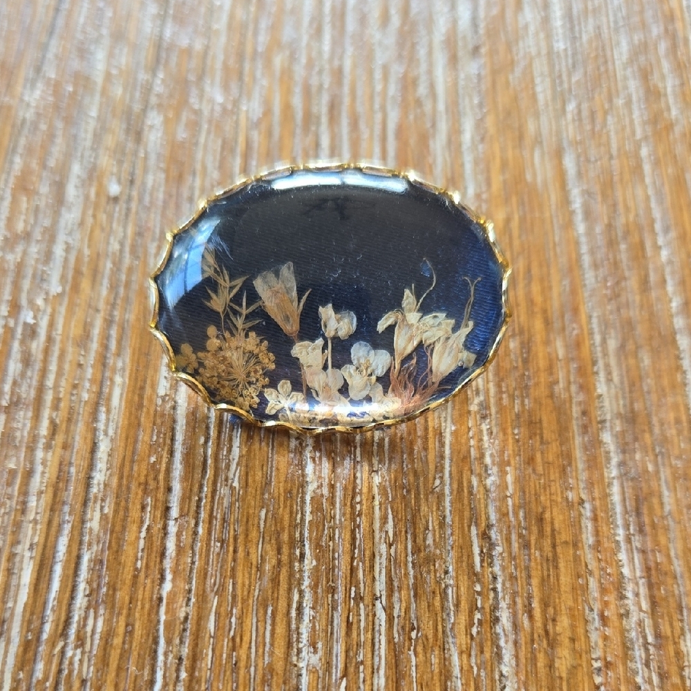 Elegant Gold and Black Floral Brooch